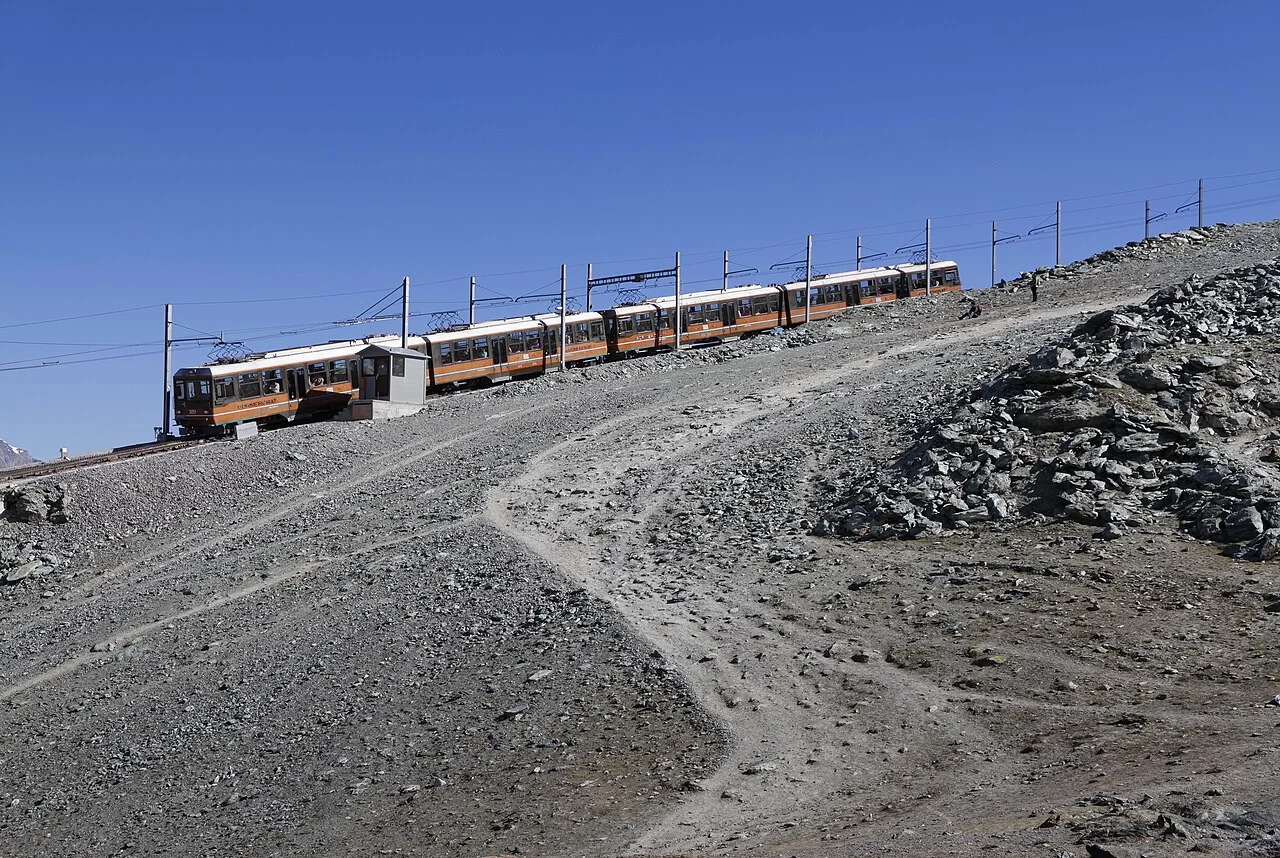 A red Gornergratbahn train in the Gornergrat area